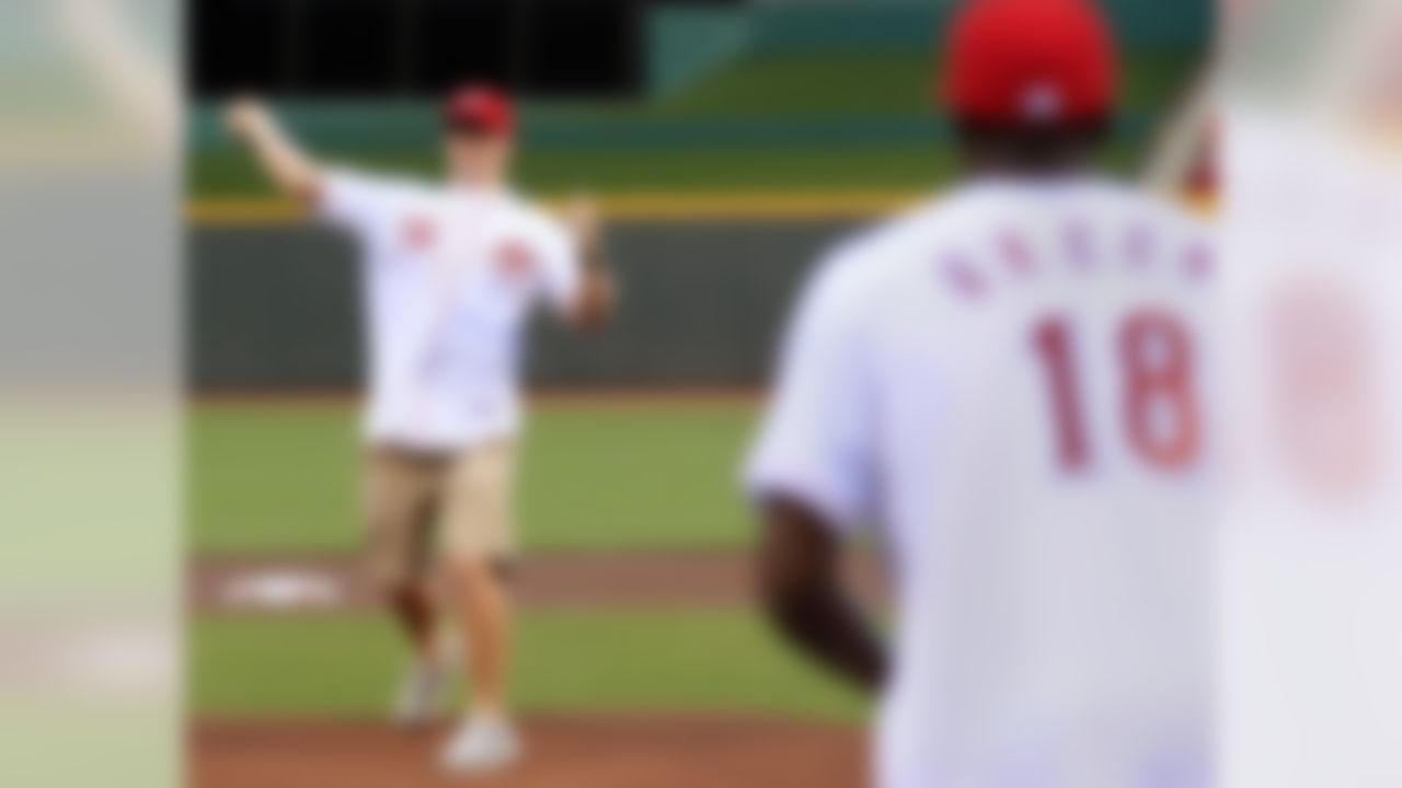 Cincinnati Bengals quarterback Andy Dalton (14) throws a ceremonial first pitch to wide receiver A.J. Green (18) prior to a baseball game between the Cincinnati Reds and the Philadelphia Phillies, Tuesday, Sept. 4, 2012, in Cincinnati. (AP Photo/Al Behrman)