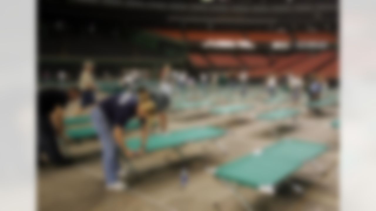 Volunteers set up cots on the floor of Houston's Astrodome on Thursday, Sept. 1, 2005, awaiting evacuees from Hurricane Katrina. (AP Photo/Pat Sullivan)