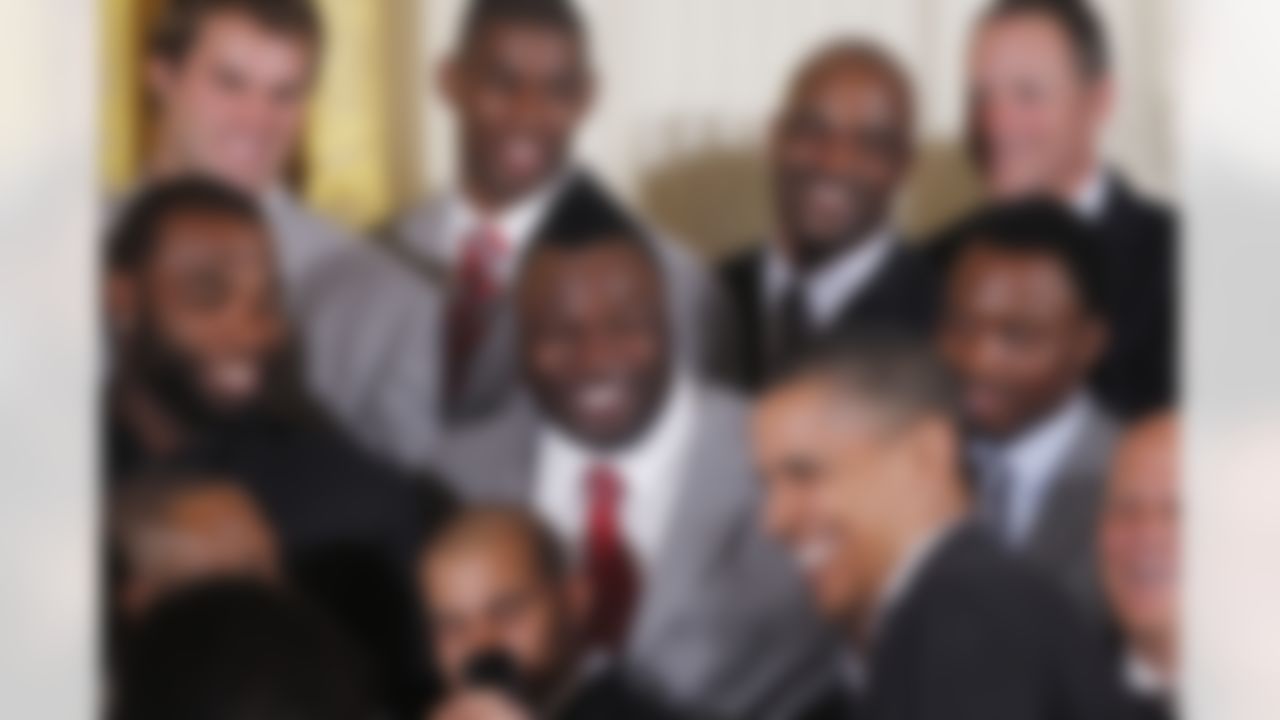 President Barack Obama jokes with 2009 NFL Super Bowl Football Champions New Orleans Saints during a ceremony in the East Room of the White House in Washington, Monday, Aug. 9, 2010. Saints defensive tackle Remi Ayodele, with Mohawk, is at center. (AP Photo/Charles Dharapak)