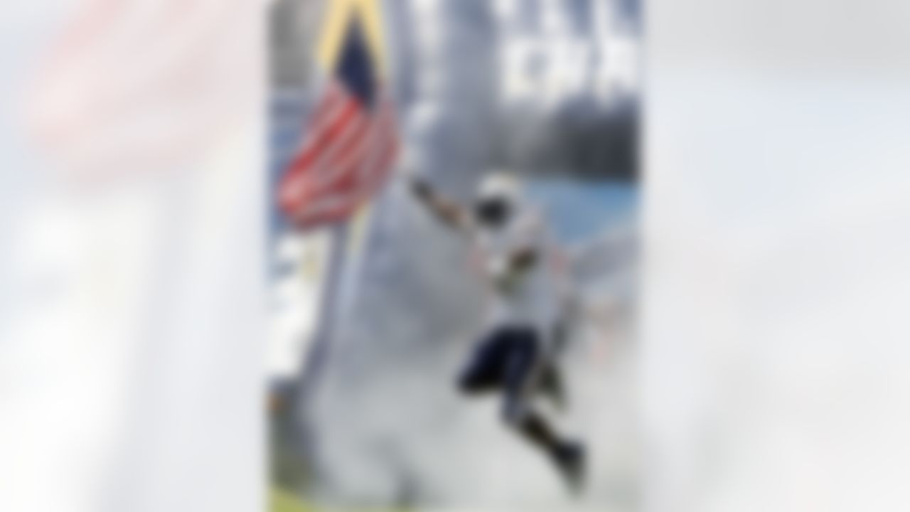 San Diego Chargers running back LaDainian Tomlinson jumps in the air with the American flag as he is introduced before an NFL football game against the Chicago Bears Sunday, Sept. 9, 2007, in San Diego. (AP Photo/Denis Poroy)