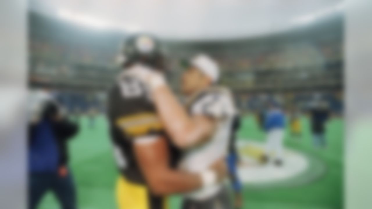 Pittsburgh Steelers Jonathan Hayes, left, (85) embraces San Diego chargers Junior Seau after the Chargers defeated the Steelers 17-13 in their AFC Championship game Sunday, Jan. 15, 1995, in Pittsburgh's Three Rivers Stadium. (AP Photo/Gene J. Puskar)