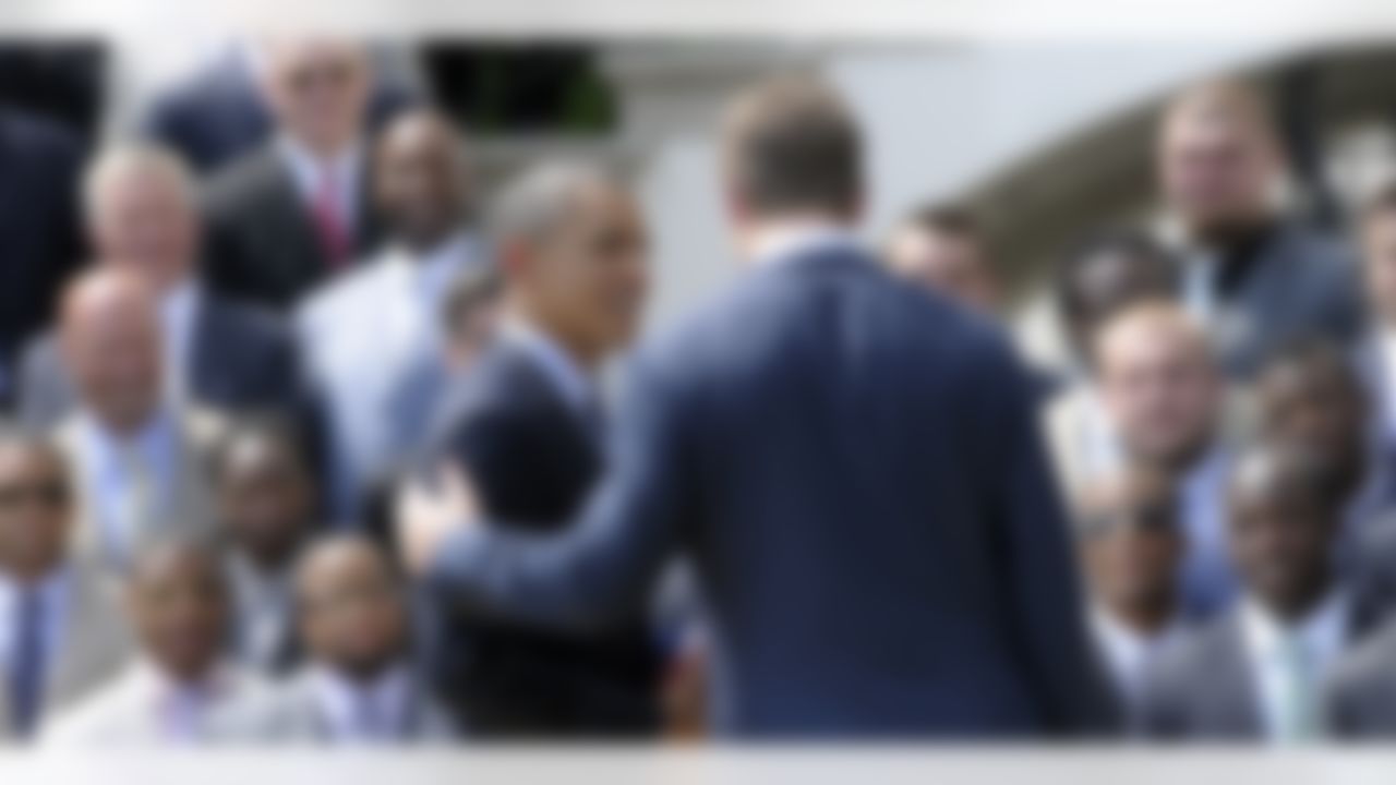 President Barack Obama talks with New York football Giants quarterback Eli Manning during a ceremony on the South Lawn of the White House in Washington, Friday, June 8, 2012, where the president honored the Super Bowl XLVI Champions. (AP Photo/Susan Walsh)