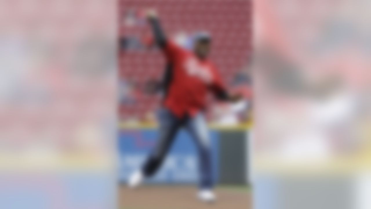 Former NFL great Cris Carter throws out a ceremonial first pitch prior to a baseball game between the Cincinnati Reds and the Atlanta Braves, Monday, May 6, 2013, in Cincinnati. Carter, set to go into the NFL Hall of Fame, is to be honored at his hometown of Middletown, Ohio, on Tuesday. (AP Photo/Al Behrman)