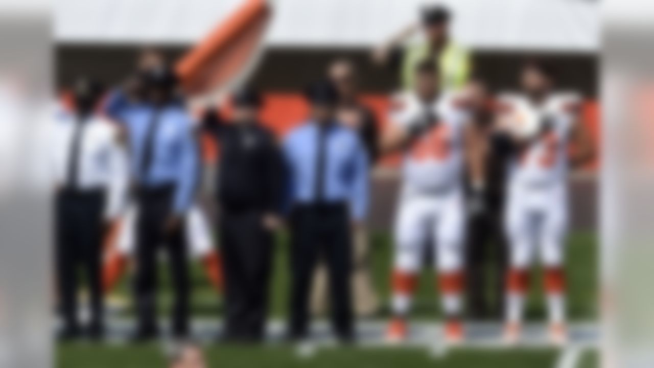 Members of the Cleveland police and the Cleveland Browns players stand together during the national anthem before an NFL football game between the Pittsburgh Steelers and the Cleveland Browns, Sunday, Sept. 10, 2017, in Cleveland.