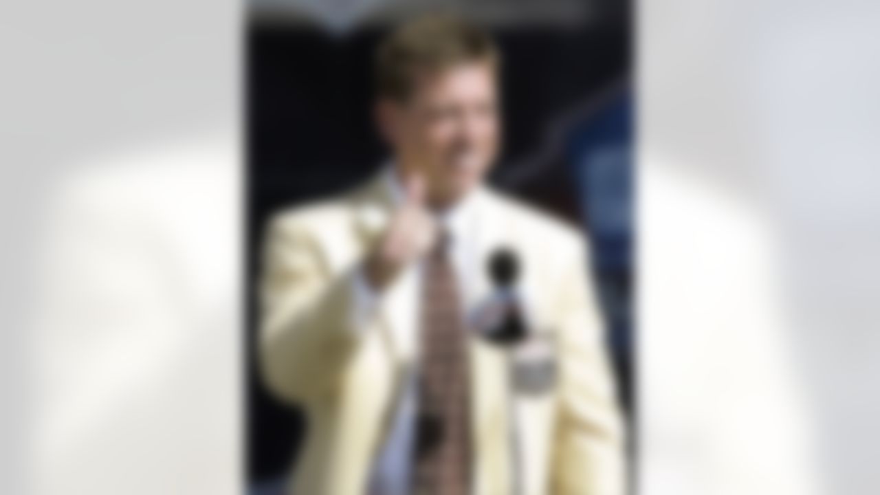 In this Aug. 5, 2006 photo, Troy Aikman gives a thumbs-up during his speech at the enshrinement ceremony at the Pro Football Hall of Fame in Canton, Ohio. Aikman's passing days didn't end when he retired from the Dallas Cowboys. The Hall of Fame quarterback says he's passed his two final college courses and will graduate in June from UCLA _ 20 years after he left for the NFL. (AP Photo/Tony Dejak)