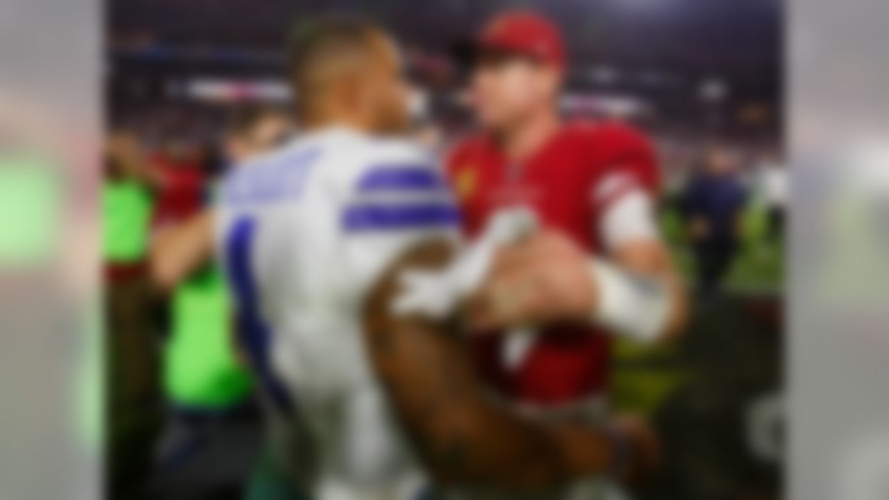 Dallas Cowboys quarterback Dak Prescott (4) and Arizona Cardinals quarterback Carson Palmer (3) meet after an NFL football game, Monday, Sept. 25, 2017, in Glendale, Ariz. The Cowboys defeated the Cardinals, 28-17.