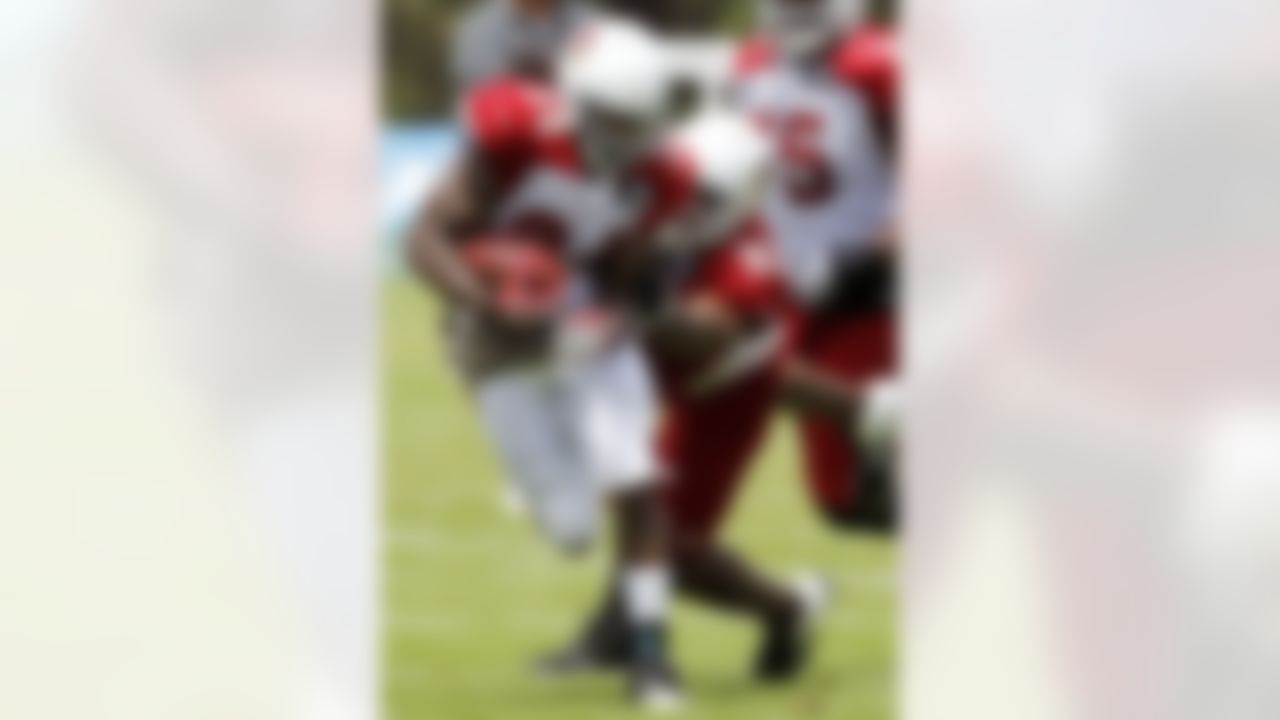 Arizona Cardinals' Ryan Williams (34) gets tackled by Calais Campbell (93) during NFL training camp football practice at Northern Arizona University Saturday, July 28, 2012, in Flagstaff, Ariz.(AP Photo/Ross D. Franklin)