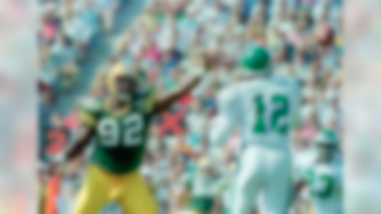 Green Bay Packers' defensive end and former Philadelphia Eagles' Reggie White (92) puts pressure on Eagles quarterback Randall Cunningham (12) during the first half, Sept. 12, 1993, in Green Bay. (AP Photo/Jerry Redfern)