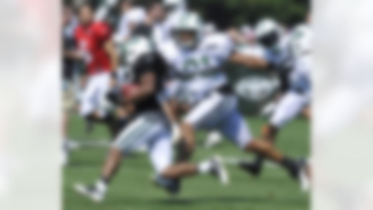 New York Jets tight end Dustin Keller, right, attempts to stop cornerback Kyle Wilson as Wilson runs back an interception at their NFL football training camp Monday, July 30, 2012, in Cortland, N.Y. (AP Photo/Bill Kostroun)