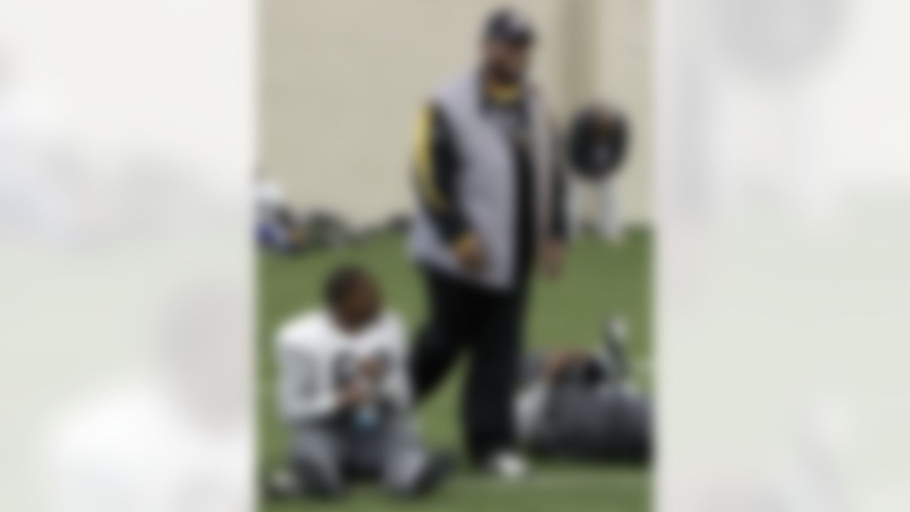 Pittsburgh Steelers head coach Mike Tomlin walks by wide receiver Emmanuel Sanders (88) during practice on Wednesday, Feb. 2, 2011, in Fort Worth, Texas. The Steelers will play the Green Bay Packers in NFL football Super Bowl XLV Sunday, Feb. 6. (AP Photo/Mark Humphrey)