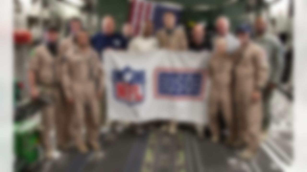 Philadelphia Eagles head coach Andy Reid (4th L), Cincinnati Bengals head coach Marvin Lewis (6th L), Minnesota Vikings head coach Brad Childress (5th R) and Carolina Panthers head coach John Fox (4th R) pose with the medical team on C-17 flight evacuating injured service members from Afghanistan to Germany on July 4, 2010. The four NFL coaches were part of a USO/Armed Forces Entertainment tour that visited Germany and Afghanistan to encourage troops. (Fred Greaves/USO)