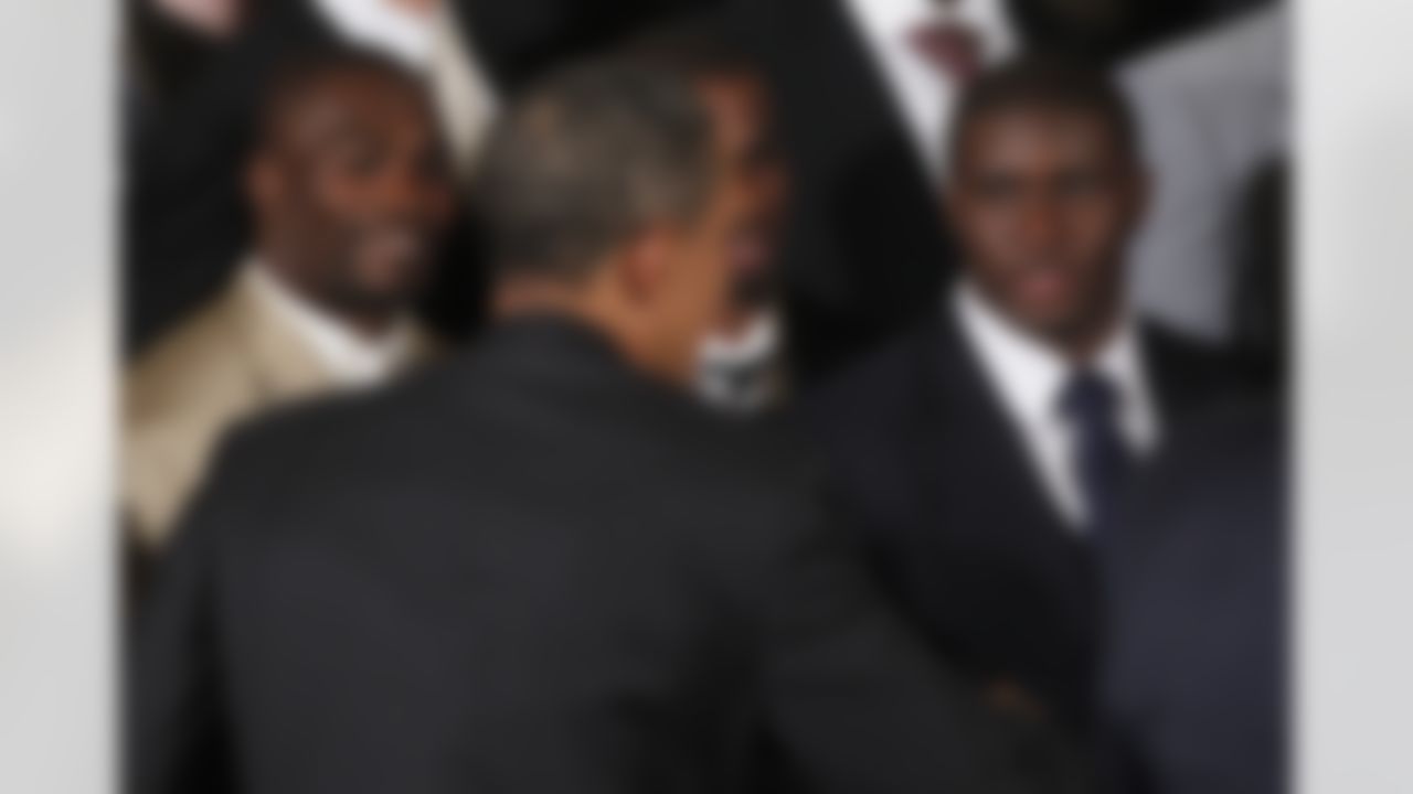 President Barack Obama greets New Orleans Saints football team running back Reggie Bush, right, Monday, Aug. 9, 2010, in the East Room of the White House in Washington, during a ceremony where the president honored the 2009 NFL Super Bowl Football Champions New Orleans Saints. (AP Photo/Charles Dharapak)