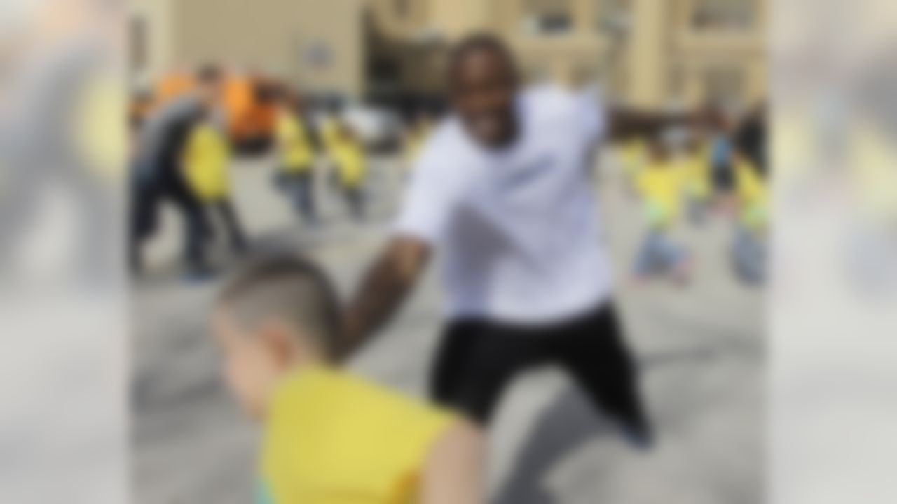 Miami Dolphins' Brandon Marshall plays tag with students at Frederick Douglass School during a BOKS function Friday, Feb. 3, 2012, in Indianapolis. BOKS, which is a before school physical activity program, is in over 300 schools nation-wide. (AP Photo/Darron Cummings)