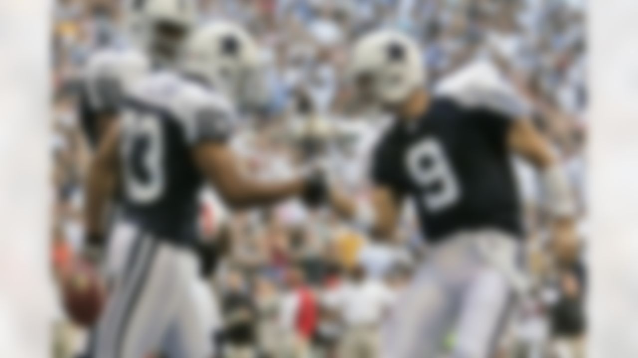 Dallas Cowboys quarterback Tony Romo (9) and receiver Terry Glenn (83) celebrate after Glenn's touchdown reception, as teammate Terrell Owens looks on in the second quarter of an NFL football game against the Tampa Bay Buccaneers in Irving, Texas, Thursday, Nov. 23, 2006. The Cowboys won 38-10 with Glenn catching two of Romo's five touchdown passes. (Tony Gutierrez/Associated Press)