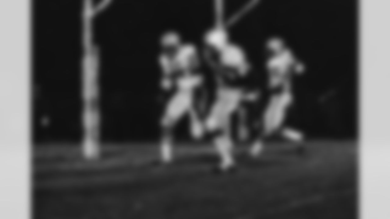 Herb Adderley (26), Green Bay Packers defensive back, grins as All-Stars' Earl McCullouch (85), from Southern California, runs after grabbing pass in fourth quarter of College All-Star game, Aug. 3, 1968, Chicago, Ill. McCullouch scored on the seven yard play, but Adderley had last laugh as Packers won game, 34-17. Packer defensive back John Rowser (45) is at right. (AP Photo)