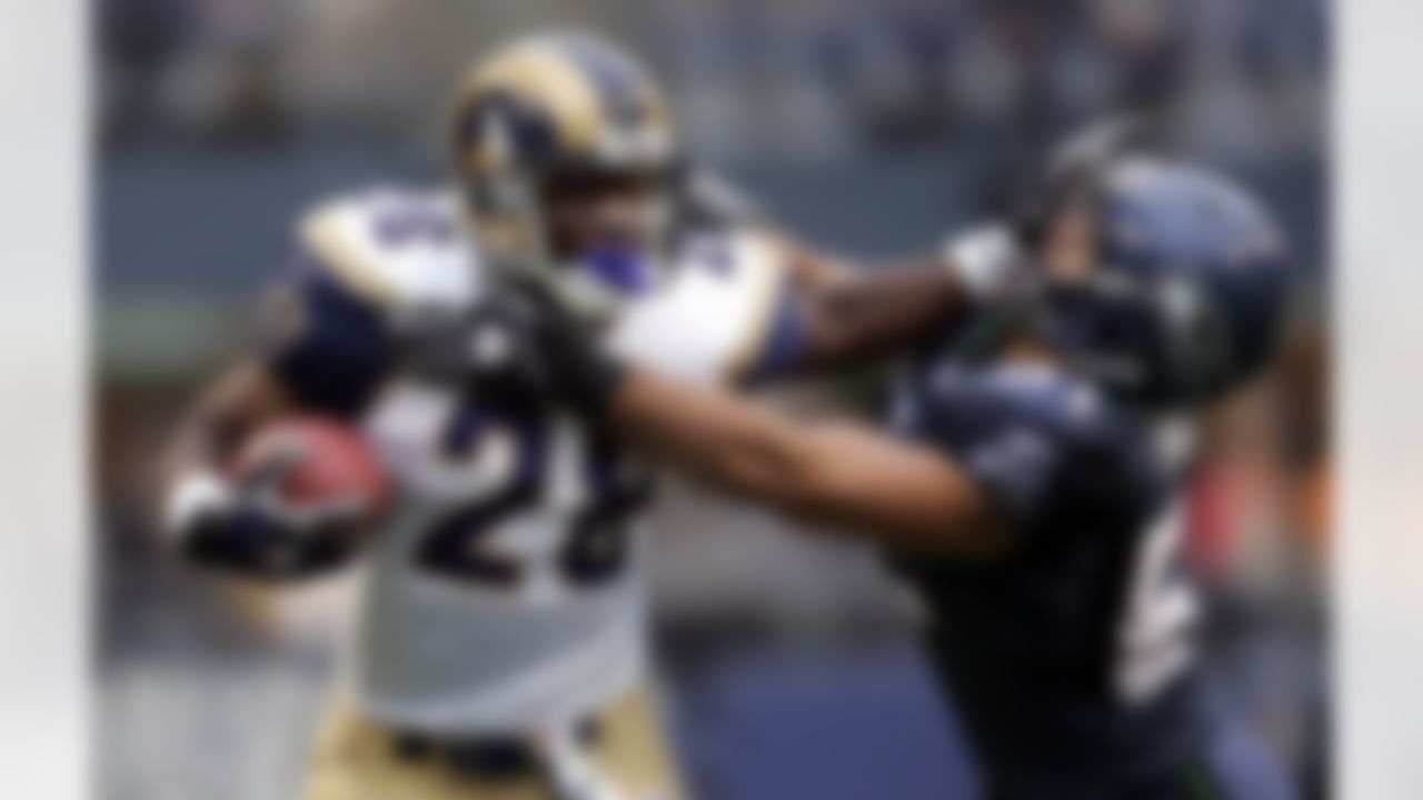 St. Louis Rams' Marshall Faulk, left, is pushed out of bounds by Seattle Seahawks' Lofa Tatupu on a second quarter, 15-yard pass reception, Sunday, Nov. 13, 2005, in Seattle. Faulk gained a first down on the play. (AP Photo/Elaine Thompson)