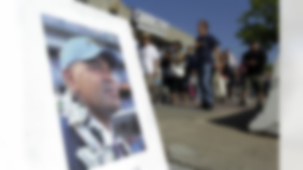 An image of football player Junior Seau is displayed in front of Qualcomm Stadium as fans arrive for a public memorial service on Friday, May 11, 2012, in San Diego. Seau committed suicide on May 2 at his Oceanside, Calif., home. He played parts of 20 seasons in the NFL, with the San Diego Chargers, Miami Dolphins and New England Patriots. (AP Photo/ Gregory Bull)