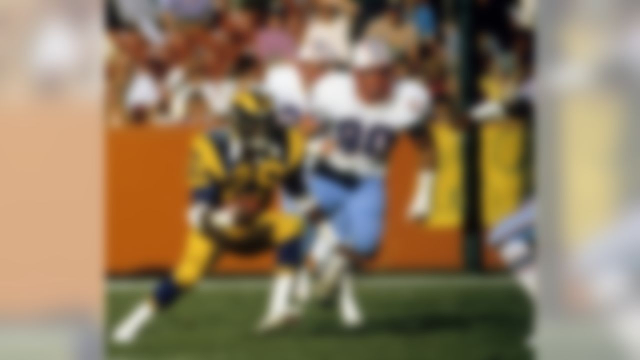 Los Angeles Rams running back Eric Dickerson (29), inducted into the Pro Football Hall of Fame class of 1999, carries the ball during a 27-16 victory over the Houston Oilers on December 9, 1984, at Anaheim Stadium in Anaheim, California. On this day, Dickerson broke O.J. Simpson's single-season rushing record. (Michael Yada/NFL)