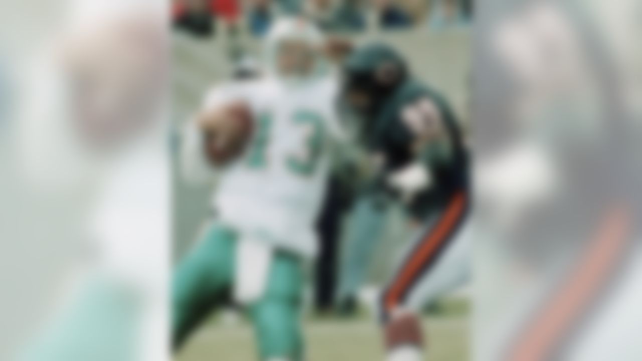 Chicago Bears' defensive end Richard Dent (95) puts pressure on Miami Dolphin quarterback Dan Marino during the first quarter on Nov. 24, 1991. (AP Photo/Fred Jewell)