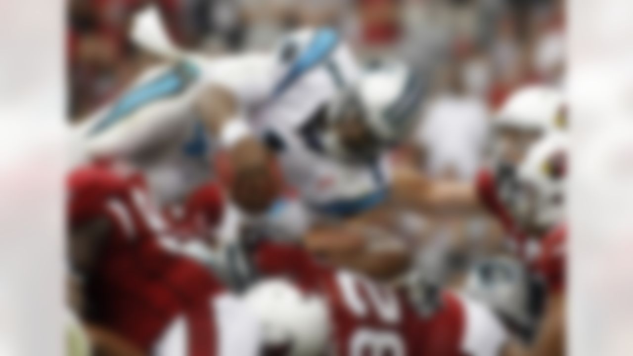 Carolina Panthers quarterback Cam Newton (1) leaps into the end zone for a touchdown against the Arizona Cardinals during the second quarter of an NFL football game on Sunday, Sept. 11, 2011, in Glendale, Ariz. (AP Photo/Ralph Freso)