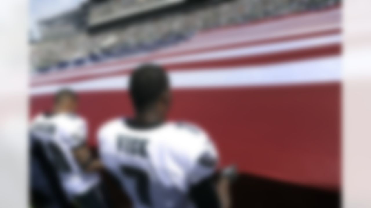 The Philadelphia Eagles' Michael Vick and DeSean Jackson hold an American flag before their team's game against the San Diego Chargers. (AP Photo/Michael Perez)