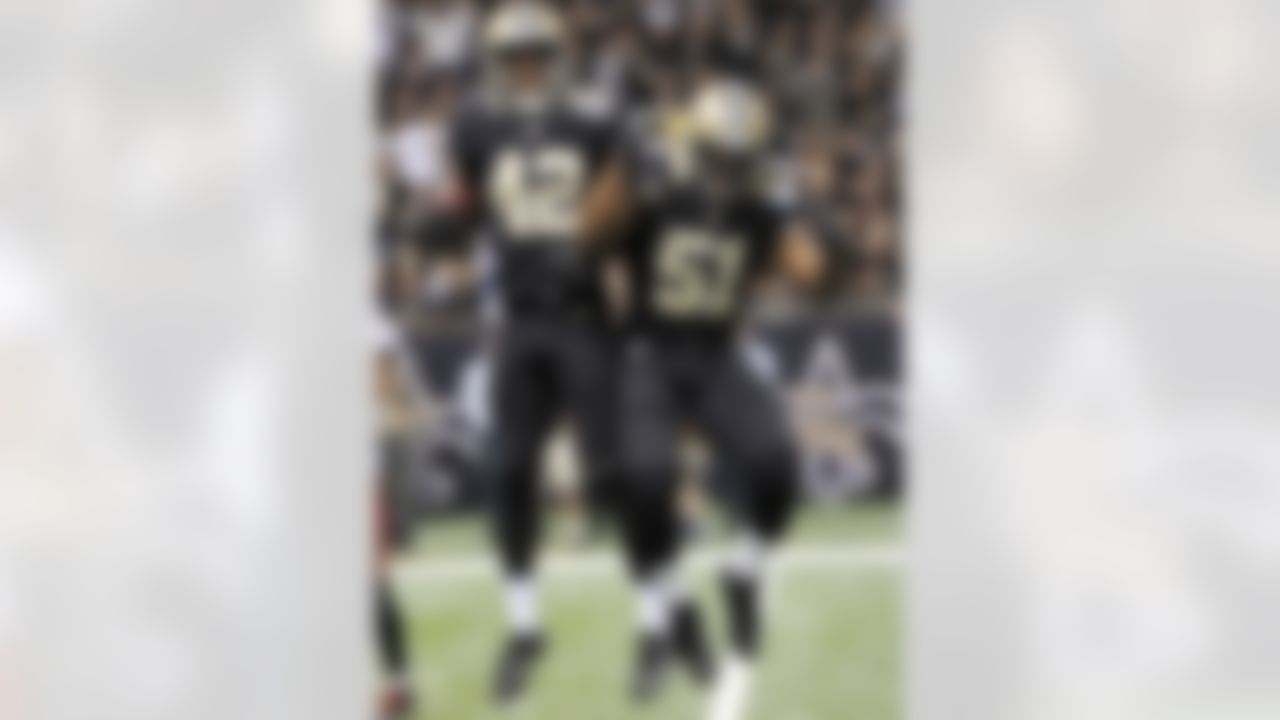 New Orleans Saints free safety Isa Abdul-Quddus (42) celebrates his interception with outside linebacker Jonathan Vilma (51) in the second half of an NFL football game against the Tampa Bay Buccaneers at the Mercedes-Benz Superdome in New Orleans, Sunday, Dec. 16, 2012. The Saints won 41-0. (AP Photo/Bill Feig)