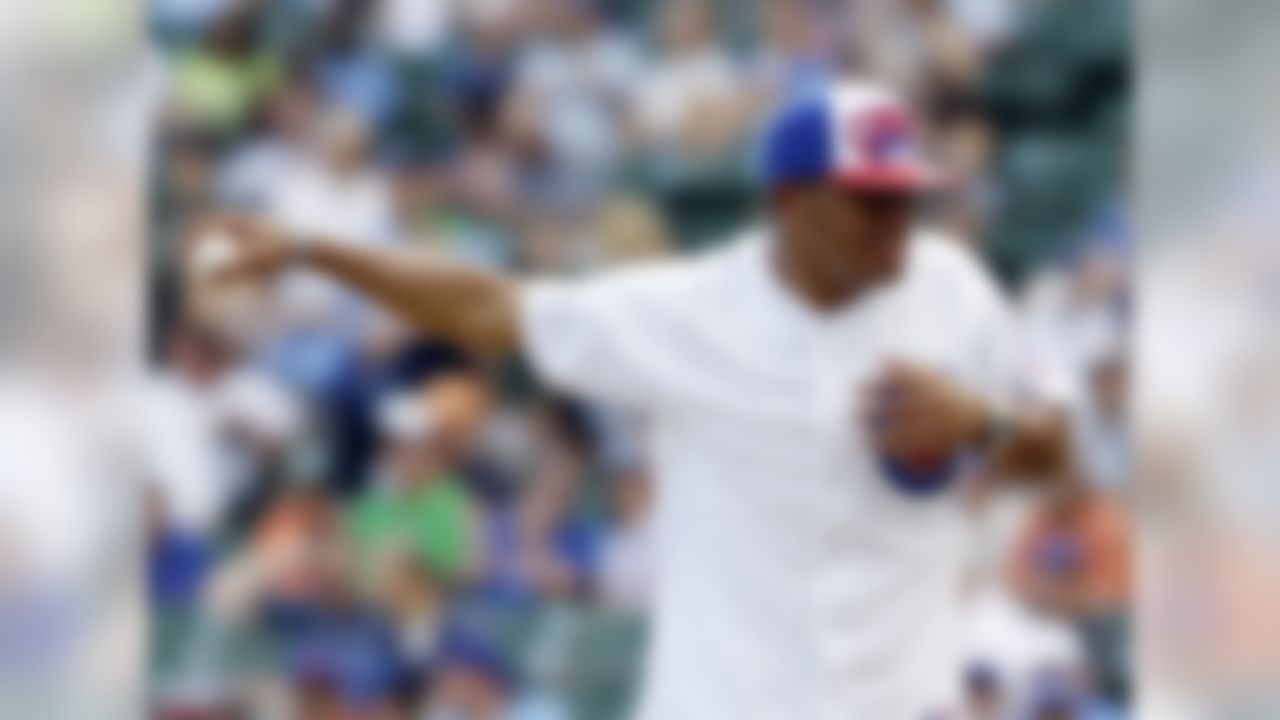 Chicago Bears running back Kahlil Bell throws out the ceremonial first pitch before a baseball game between the Arizona Diamondbacks and the Chicago Cubs in Chicago, Sunday, July 15, 2012. (AP Photo/Nam Y. Huh)