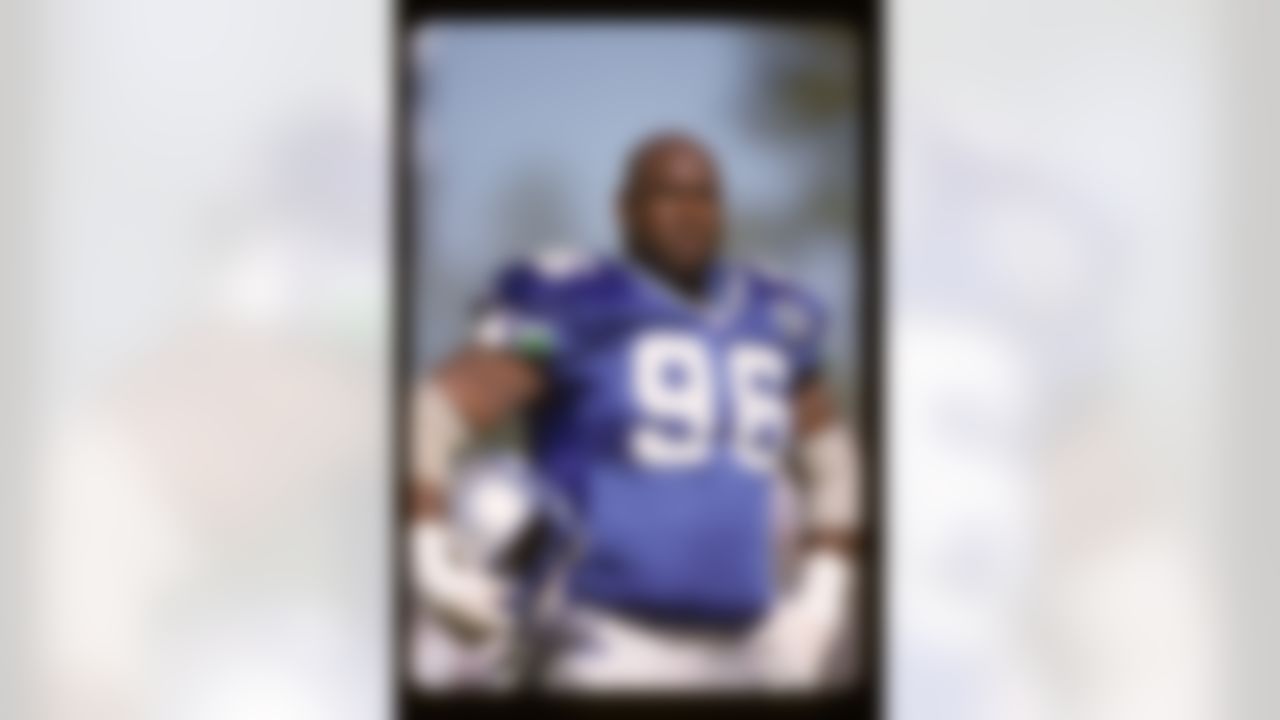 Seattle Seahawks defensive tackle Cortez Kennedy (96) looks up from the sideline with his helmet off during a NFL preseason football game against the Indianapolis Colts on August 5, 2000 in Seattle. The Seahawks won the game 28-16. (AP Photo/Paul Jasienski)