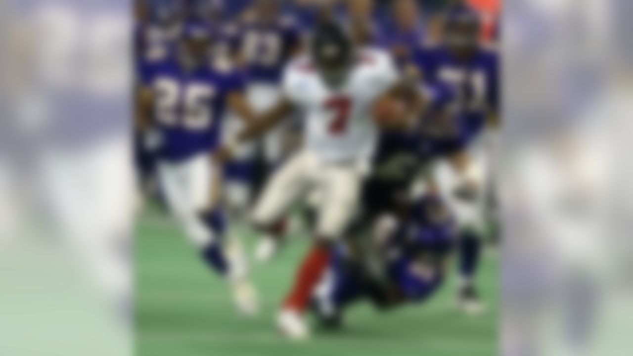 Atlanta Falcons quarterback Michael Vick (7) leaves behind Minnesota Vikings' Eric Kelly (25), Lance Johnstone (51), Greg Biekert (54) and Corey Chavous (21) on a 46-yard touchdown run in overtime in Minneapolis, Sunday, Dec. 1, 2002. The Falcons won, 30-24. (AP Photo/Tom Olmscheid)