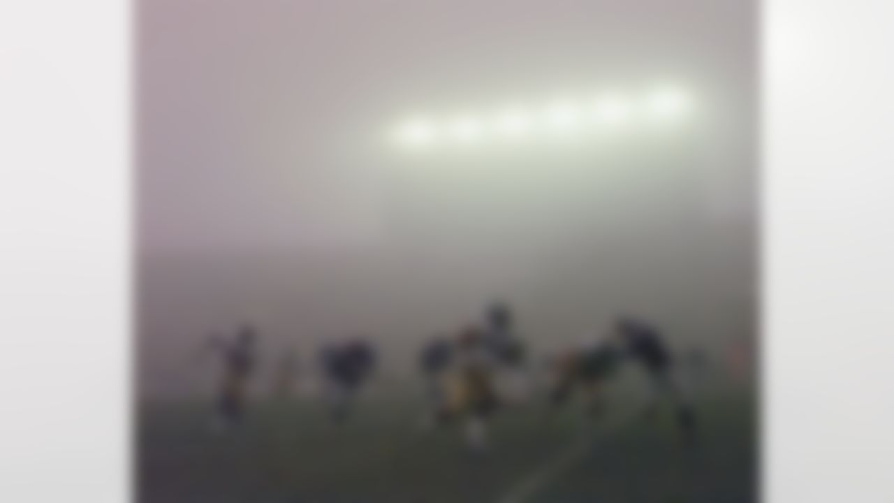 Pittsburgh Steelers center Dermontti Dawson (63) scrambles down the sidelines under the fog during his team's playoff game against the New England Patriots in Foxboro, Mass., Sunday Jan. 5, 1997. The Patriots beat the Steelers 28-3. (AP Photo/Charles Krupa)