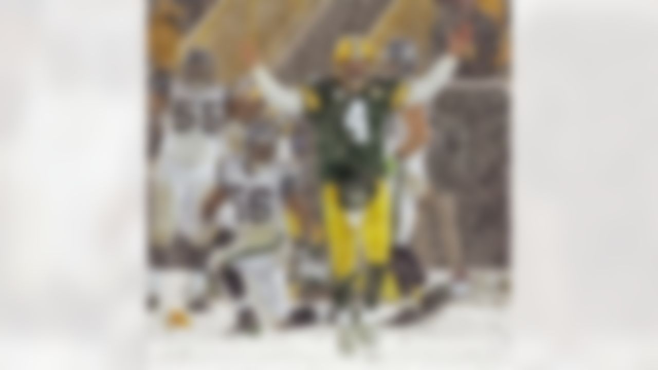 Green Bay Packers quarterback Brett Favre celebrates in the snow during the second half of an NFL football game against the Seattle Seahawks in Green Bay, Wis. on this Jan. 12, 2008. The Packers won 42-20. (AP Photo/Mike Roemer)