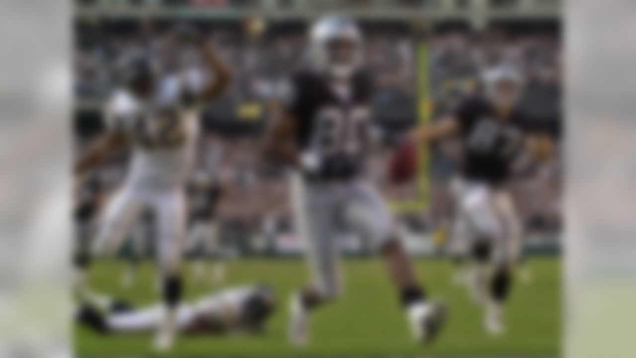 Oakland Raiders' wide receiver Jerry Rice (80) scores his third touchdown of the game against the San Diego Chargers during the fourth quarter Sunday, Nov. 18, 2001, in Oakland, Calif. At left is Chargers' safety Rogers Beckett, at right is Raiders' Jeremy Brigham. The Raiders defeated the Chargers 34-24. (AP Photo/Ben Margot)