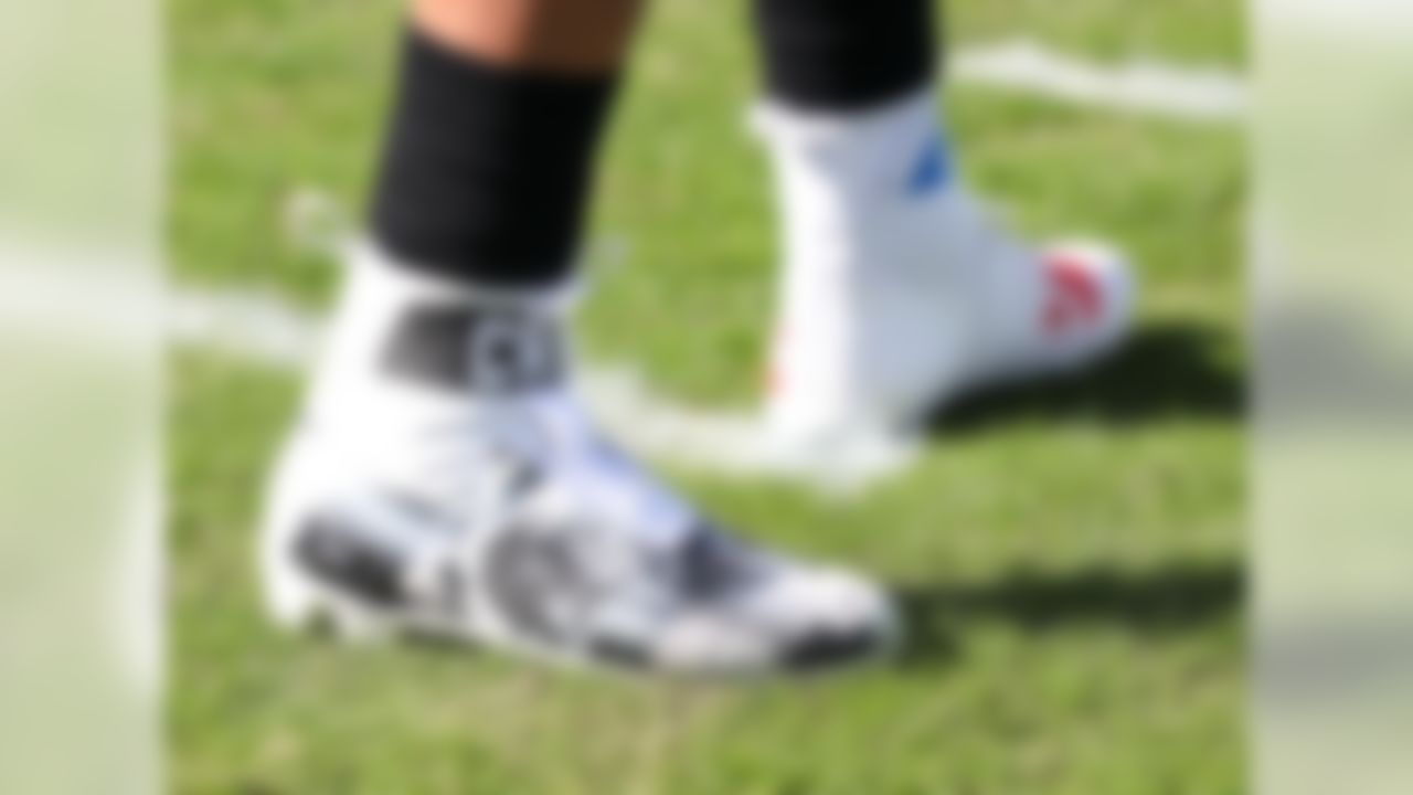 Carolina Panthers' Cam Newton wears custom cleats as he warms up before an NFL football game against the Seattle Seahawks in Charlotte, N.C., Sunday, Nov. 25, 2018.