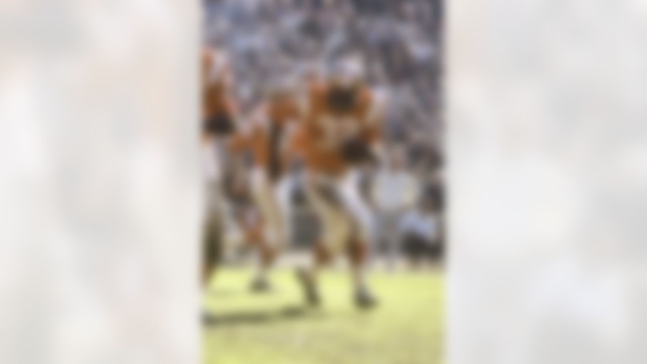 Cleveland Browns running back Jim Brown #32 of the East runs behind Cleveland Browns guard John Wooten #60 against the West in the 1966 NFL Pro Bowl at the Los Angeles Memorial Coliseum on January 15, 1966 in Los Angeles, California. The East defeated the West 36-7. (National Football League)