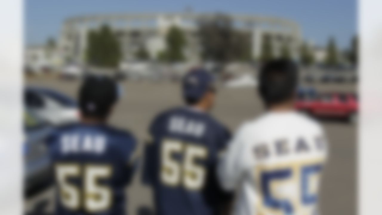 From left to right, Ariel Alcala, Mike Santos and John Aguimatang wait for a public memorial service for football player Junior Seau at Qualcomm Stadium, Friday, May 11, 2012, in San Diego. Seau committed suicide on May 2 at his Oceanside, Calif., home. He played parts of 20 seasons in the NFL, with the San Diego Chargers, Miami Dolphins and New England Patriots. (AP Photo/Gregory Bull)