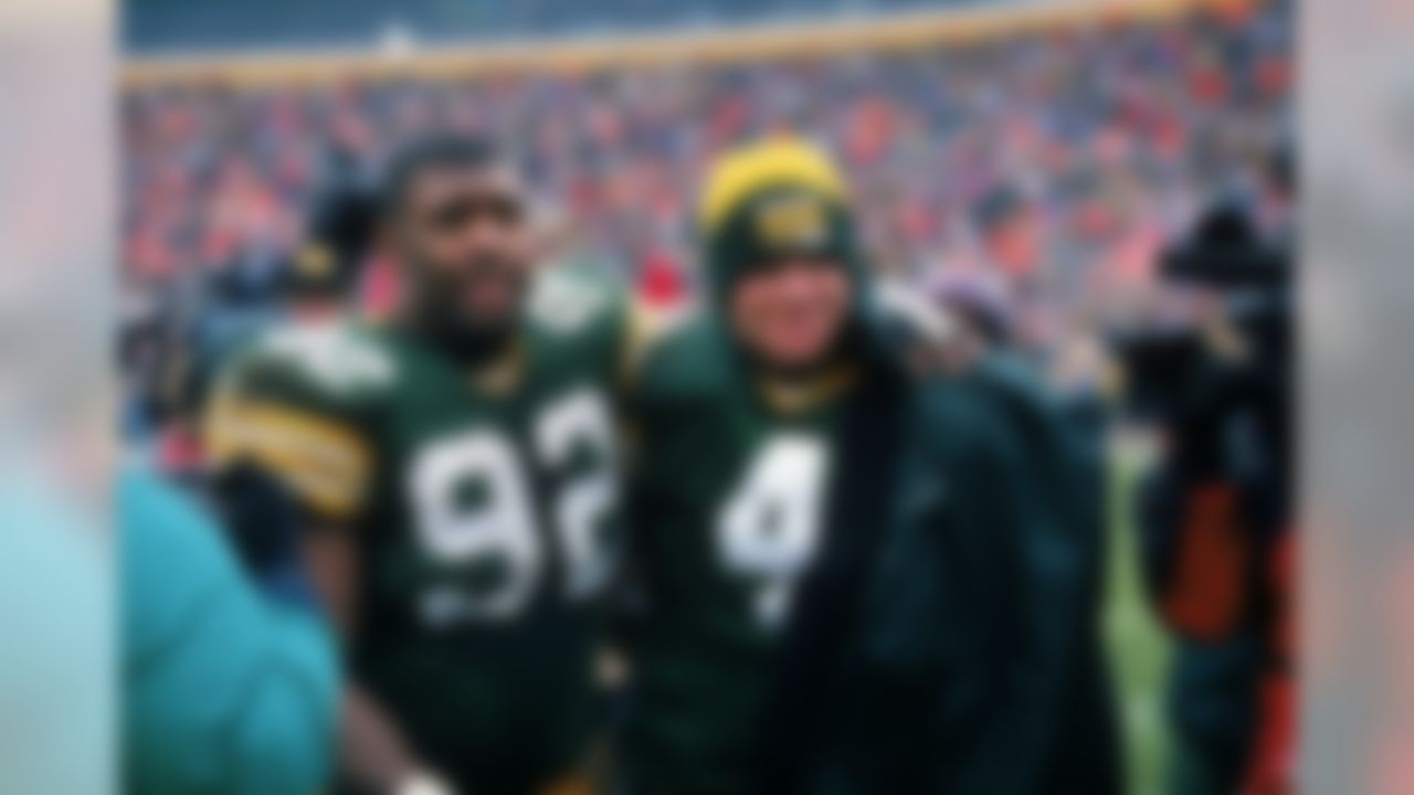 Green Bay Packers efensive end Reggie White (92) and quarterback Brett Favre (4) celebrate after an NFL football game against the Chicago Bears at Lambeau Field on November 12, 1995 in Green Bay, Wisconsin. The Packers won 35-28. (AP Photo/David Stluka)
