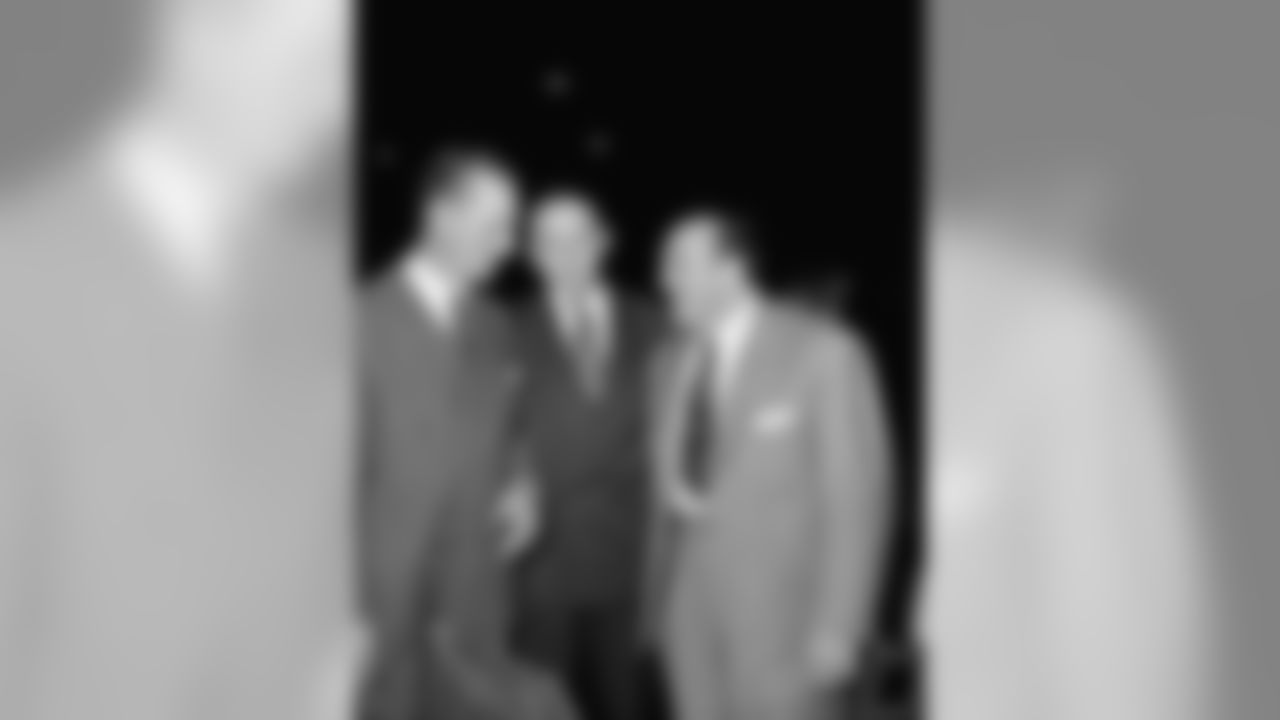 Don Hutson, Clarke Hinkle and Buckets Goldenberg, Former Green Bay Packer Pro Football Stars, talk over old times at Formal Dedication of Wisconsin's sports hall of fame at the Milwaukee Arena in Milwaukee, Wisconsin at night on Wednesday, Nov. 28, 1951. (AP Photo/Gene Herrick)