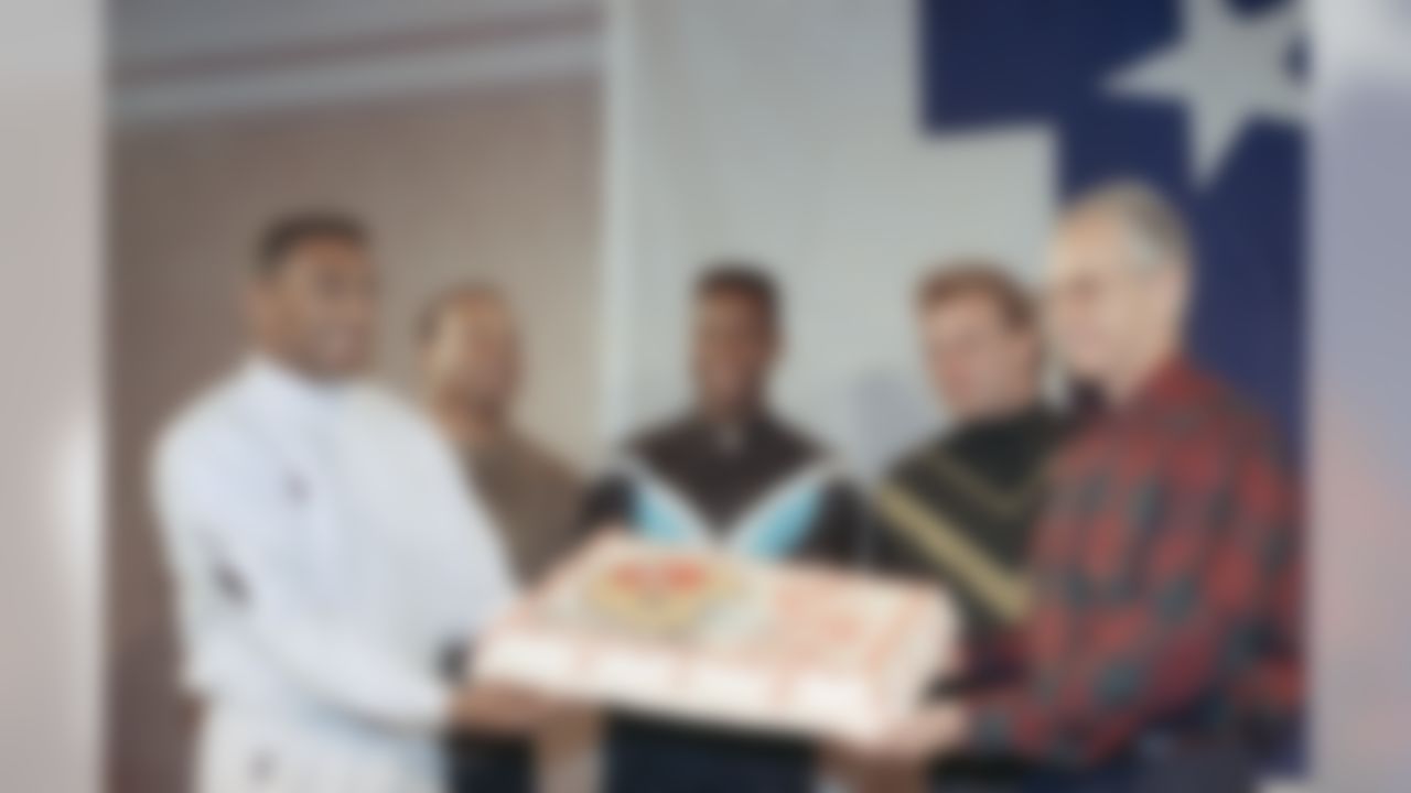 San Francisco 49ers (left to right) Roger Craig, Ronnie Lott, Jerry Rice and Joe Montana present coach George Seifert with a birthday cake during a press briefing in New Orleans on Jan. 22, 1990. Seifert celebrated his 50th birthday. The 49ers play the Denver Broncos on Sunday in Super Bowl XXIV. (AP Photo/Eric Risberg)