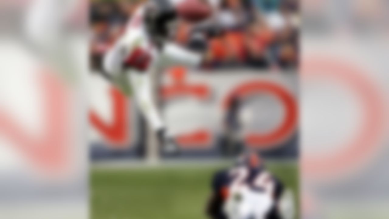 Atlanta Falcons quarterback Michael Vick (7) sails through the air after being tripped up by Denver Broncos cornerback Champ Bailey (24) during the second quarter in Denver, on Sunday, Oct. 31, 2004. (AP Photo/Jack Dempsey)