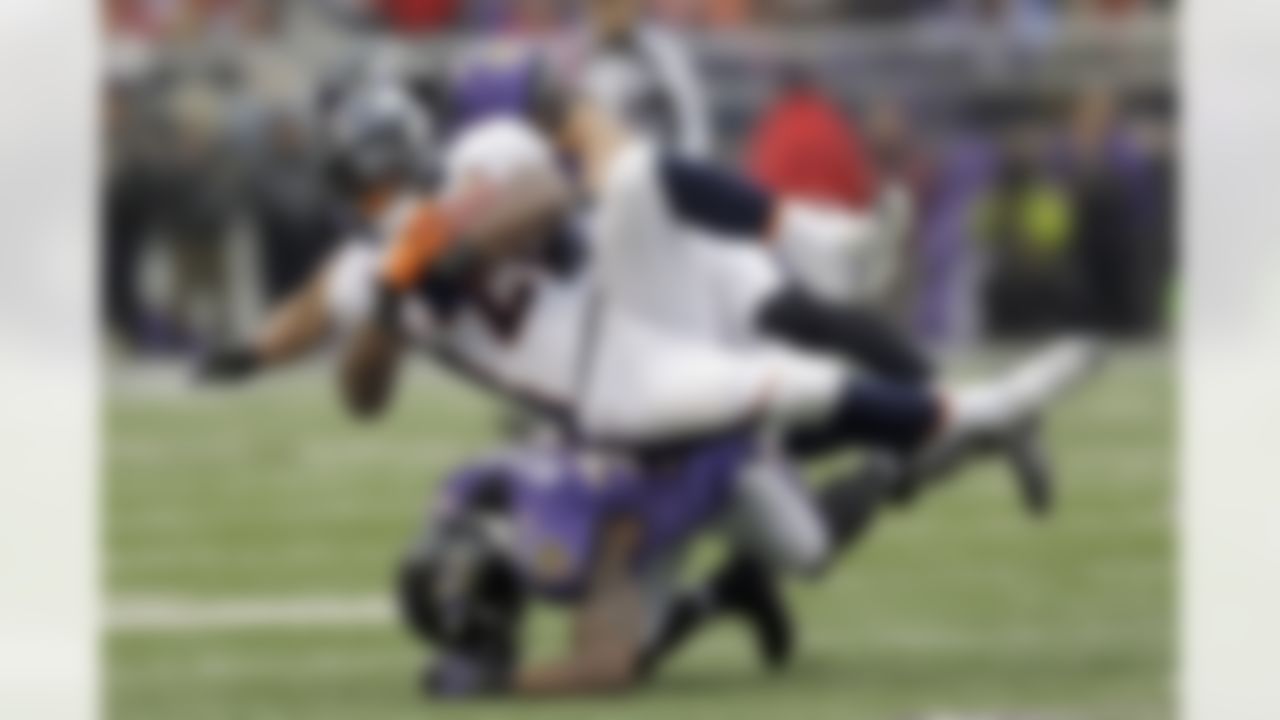 Denver Broncos running back Knowshon Moreno is stopped by Baltimore Ravens inside linebacker Brendon Ayanbadejo, top, and defensive back James Ihedigbo, bottom during the first half of an NFL football game in Baltimore, Sunday, Dec. 16, 2012. (AP Photo/Patrick Semansky)