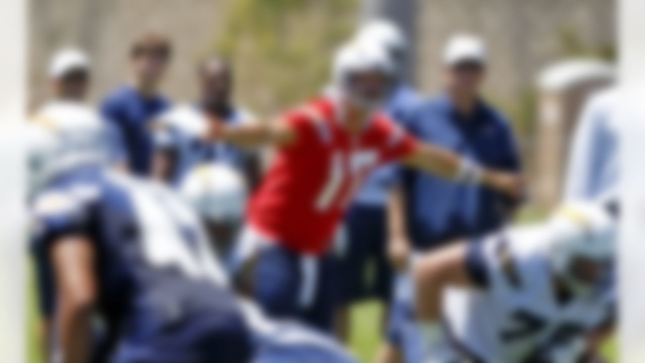 San Diego Chargers quarterback Philip Rivers gives directions before the snap as coach Norv Turner, rear right, looks on during NFL football practice at the team's training camp, Tuesday, July 24, 2012 in San Diego. (AP Photo/Lenny Ignelzi)