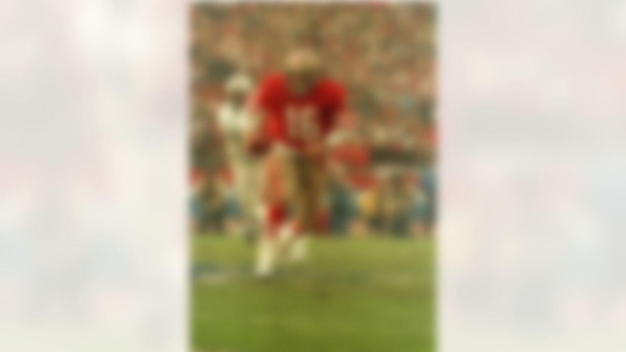 San Francisco 49ers quarterback Joe Montana (16) tucks the ball and scampers for a first half first down during the Super Bowl XIX at Stanford Stadium in Stanford, CA on January 20, 1985. (Associated Press)