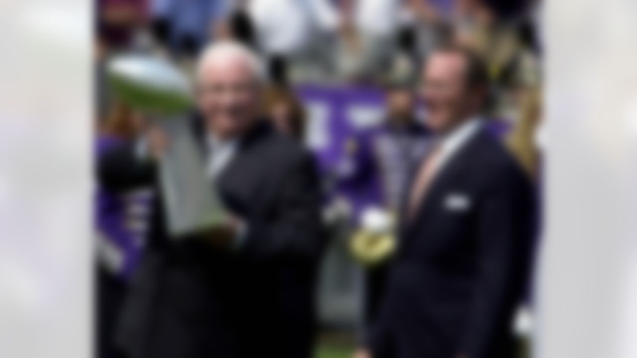 Baltimore Ravens owner Art Modell, left, and his son David Modell acknowledge the fans while holding the Vince Lombardi Super Bowl trophy prior to the game against the Chicago Bears, Sunday, Sept. 9, 2001 at PSINet Stadium in Baltimore.(AP Photo/Ricky Carioti)