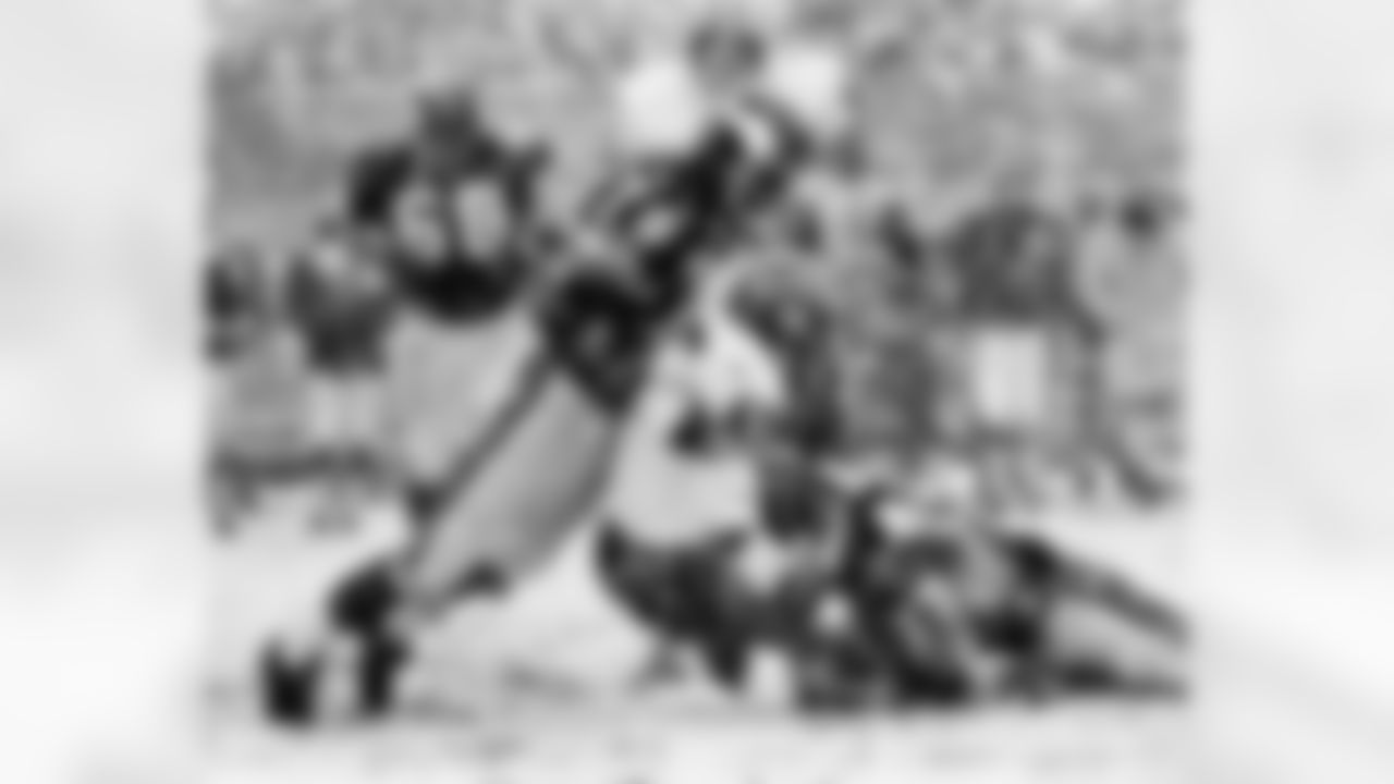San Francisco running back Bill Tucker of the San Francisco 49ers gets stopped by Minnesota defensive end Jim Marshall (70) and Gary Larsen (77) in a 10-7 Vikings win on December 14,1969. (National Football League)