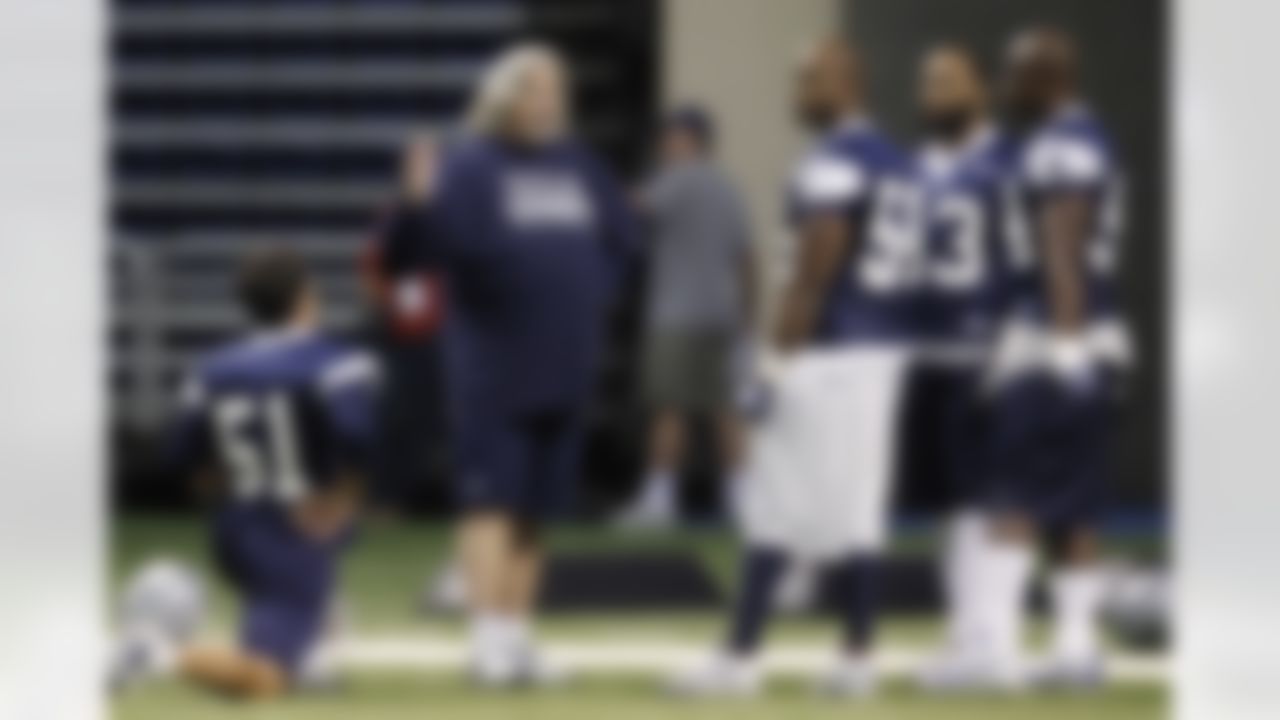 Dallas Cowboys defensive coordinator Rob Ryan, second from left, talks with Keith Brooking (51), Bradie James (56), Anthony Spencer (93) and DeMarcus Ware, right, during NFL football training camp, Friday, July 29, 2011, in San Antonio. (AP Photo/Eric Gay)