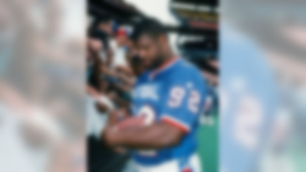 NFC player Reggie White (92) signs autographs during the Pro Bowl between the AFC and the NFC on February 6, 1994 in Honolulu, Hawaii. The NFC won the game 17-3. (AP Photo/Paul Spinelli)