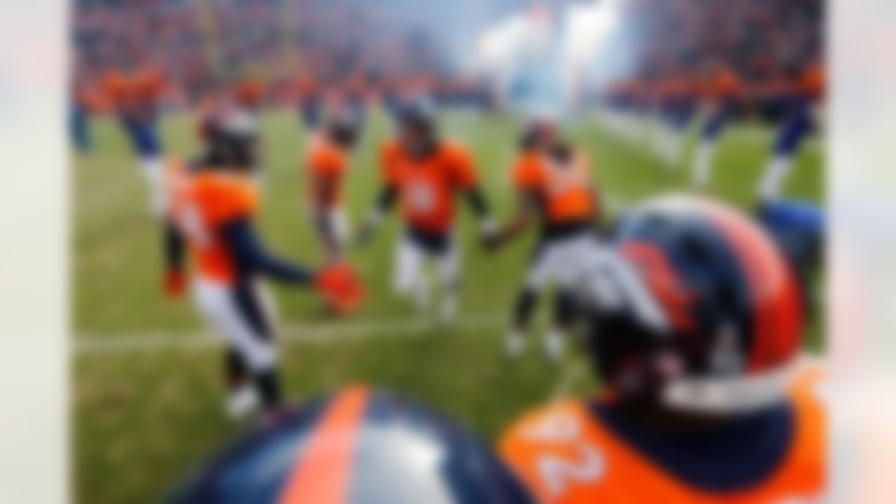 Denver Broncos quarterback Peyton Manning (18) is greeted by Denver Broncos outside linebacker Wesley Woodyard (52), Denver Broncos free safety David Bruton (30) and Denver Broncos outside linebacker Von Miller (58) prior to the AFC Divisional playoff game between the Baltimore Ravens and the Denver Broncos at Sports Authority Field at Mile High in Denver, Colorado on January 12, 2013. (Ric Tapia/NFL)