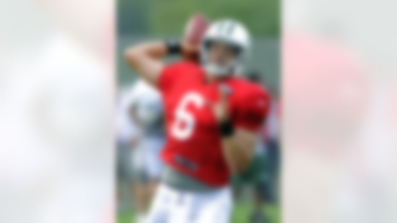 New York Jets quarterback Mark Sanchez passes the ball at NFL football training camp on Sunday, July 29, 2012, in Cortland, N.Y. (AP Photo/Bill Kostroun)