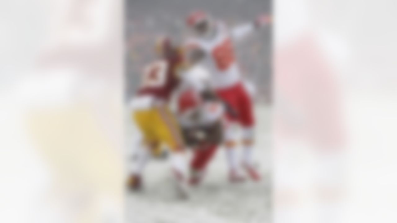Kansas City Chiefs wide receiver Dexter McCluster (22) slides between Washington Redskins cornerback DeAngelo Hall (23) and wide receiver Junior Hemingway (88) during the first half of an NFL football game in Landover, Md., Sunday, Dec. 8, 2013. (AP Photo/Evan Vucci)