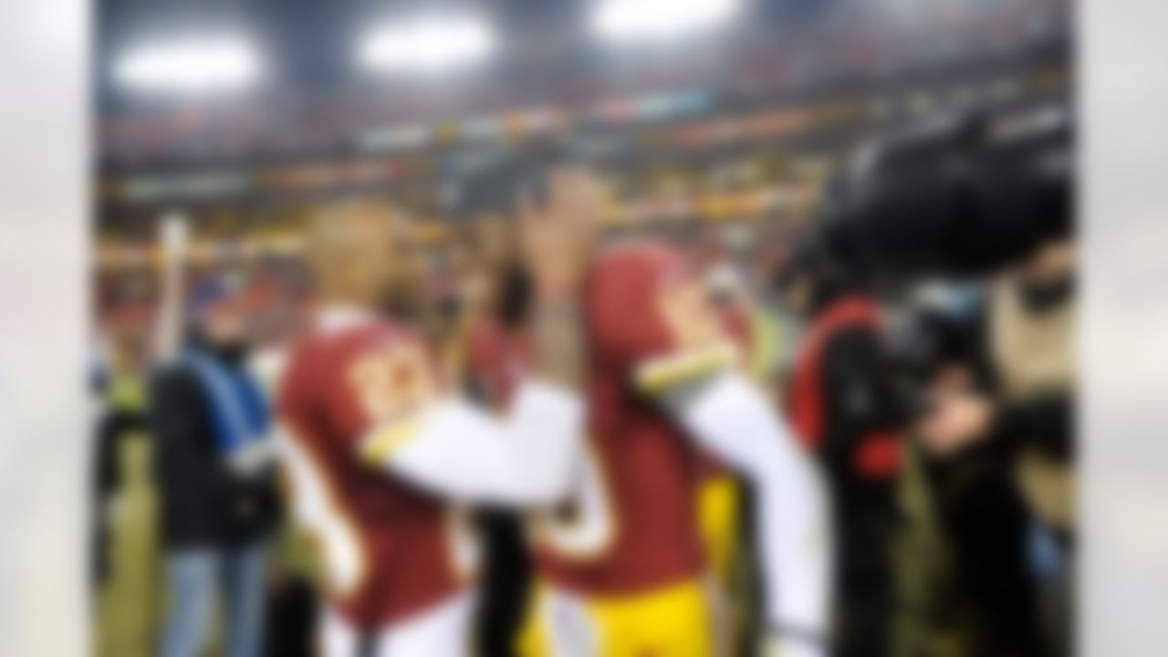 Washington Redskins cornerback DeAngelo Hall (23) celebrates with Washington Redskins quarterback Robert Griffin III (10) after an NFL football game against the Dallas Cowboys Sunday, Dec. 30, 2012, in Landover, Md. The Redskins won 28-18, securing a playoff berth.